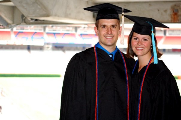a man and a woman in graduation caps and gowns